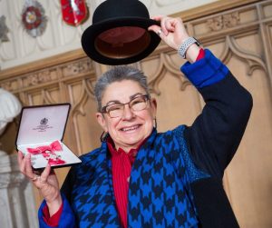 MICHÈLE TAYLOR proudly holds her MBE