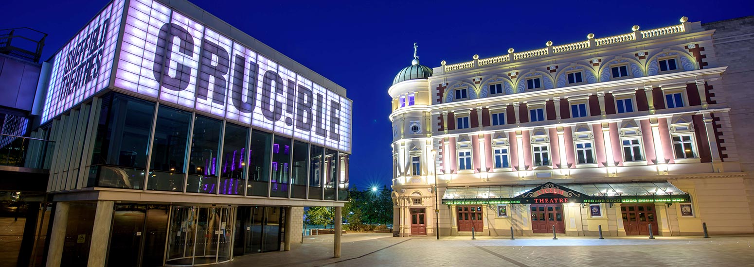A photo of the Crucible and Lyceum theatres at night - all their lights are on