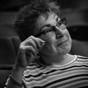 A head and shoulders photo of michele Taylor, Ramps on the Moon. Michele is looking upwards and smiling 