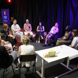 A group of people sitting in a circle in a workshop